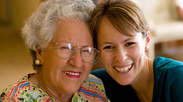 Elderly woman and a younger woman smiling