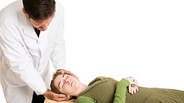 Patient receiving chiropractic adjustment of the neck