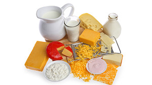 Group of dairy foods including milk and cheese.