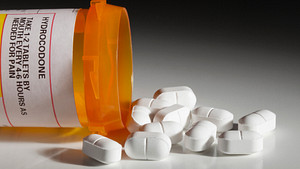 Hydrocodone opioid medication spilled on tabletop