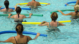 Group performing water aerobics in a pool