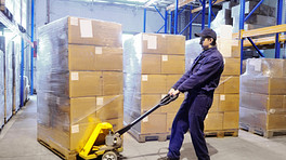 Using a hand truck in a warehouse.