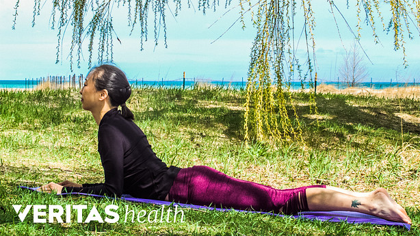 Woman outdoors performing the press up stretch.