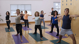 Yoga class doing warrior 2 yoga pose