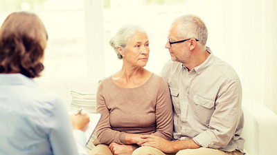 Elderly couple talking with a physician.