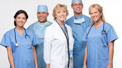 Medical team in scrubs and a doctor.