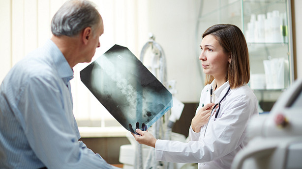 Doctor and patient reviewing the patient&#039;s x-ray.