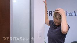 Woman doing a levator scapula stretch