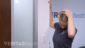 Woman doing a levator scapula stretch