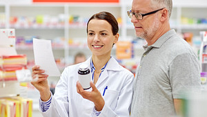 Pharmacist reviews medication with patient