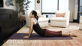 Woman lying prone performing the press up stretch.