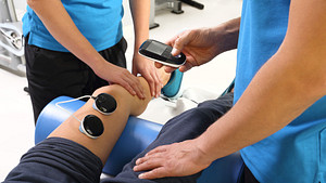 Cold Laser Therapy being performed on the leg