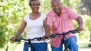 An older couple riding their bikes