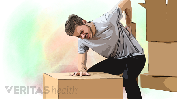 A man trying to lift heavy object is in pain.