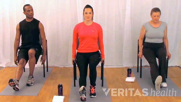 three people performing seated hamstring stretch for sciatica from a herniated disc