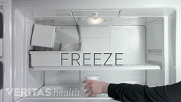 Putting a styrofoam cup in the freezer to freeze.